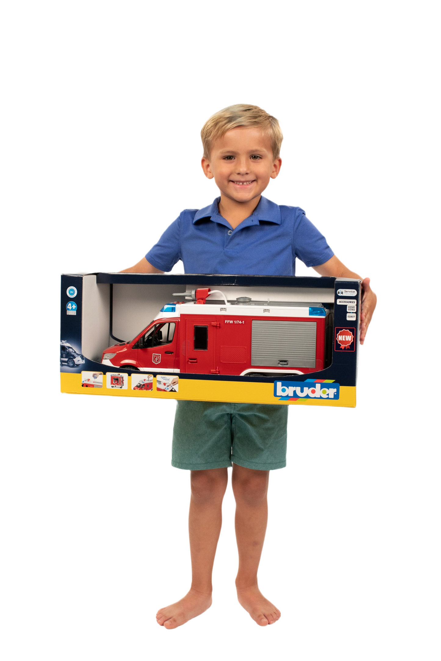 Child holding a boxed red Bruder MB Sprinter fire engine toy featuring side compartment and roof details