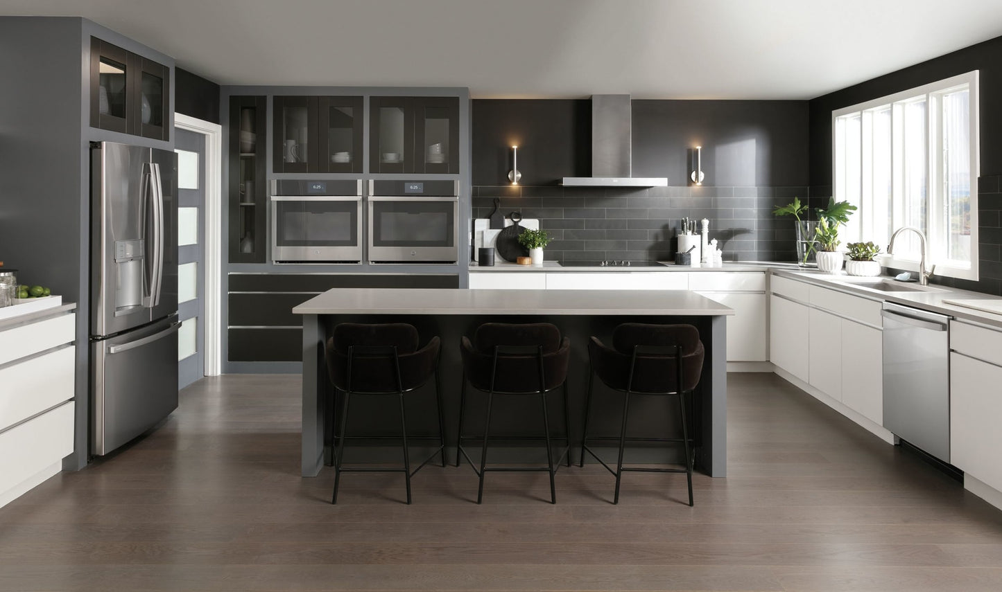 Modern kitchen with a sleek 36-inch smart wall mount hood and perimeter venting, featuring dark cabinetry and stainless appliances.