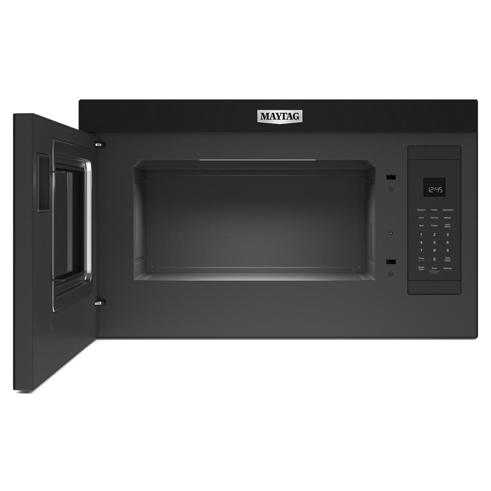Open black over-the-range microwave with digital control panel in kitchen appliances collection