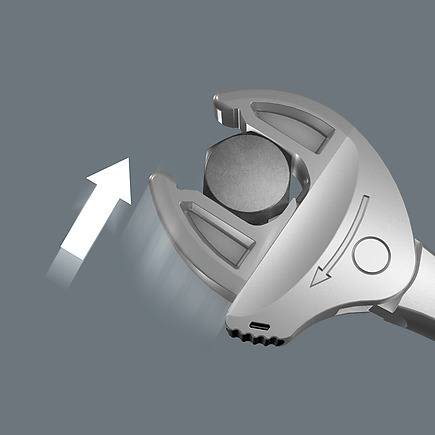 Close-up of silver adjustable spanner gripping hex bolt with arrow indicating jaw movement for home improvement tasks