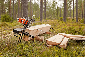 Timberjig sawmill attachment clamped to guide rails cutting thick log beams outdoors for woodworking and home improvement tasks