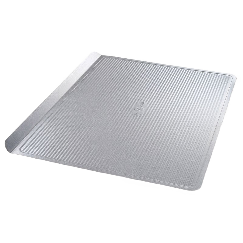 Large durable aluminum cookie sheet pan with raised edges for even baking and easy handling in the kitchen
