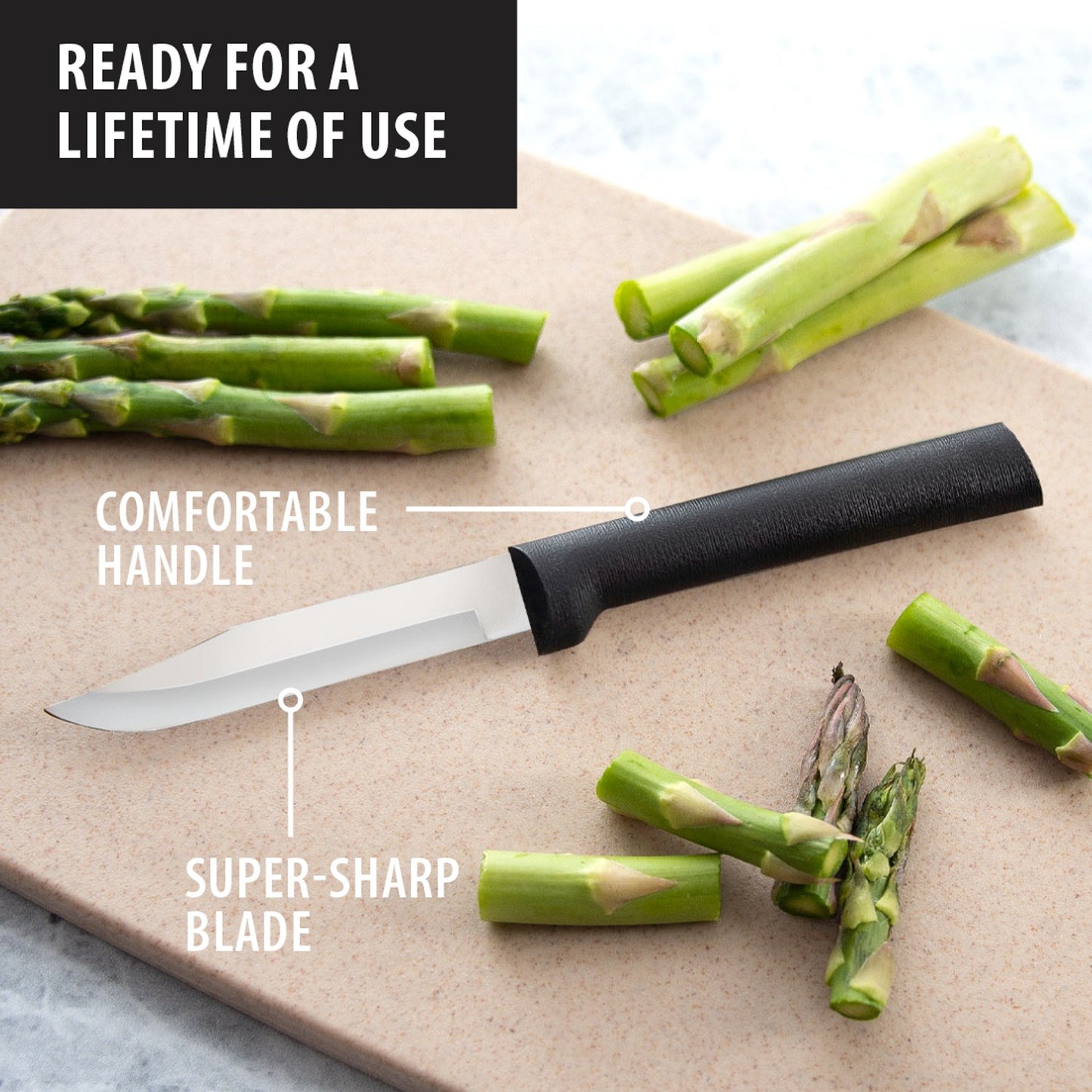 Paring knife with black textured handle and sharp blade slicing fresh asparagus on light cutting board