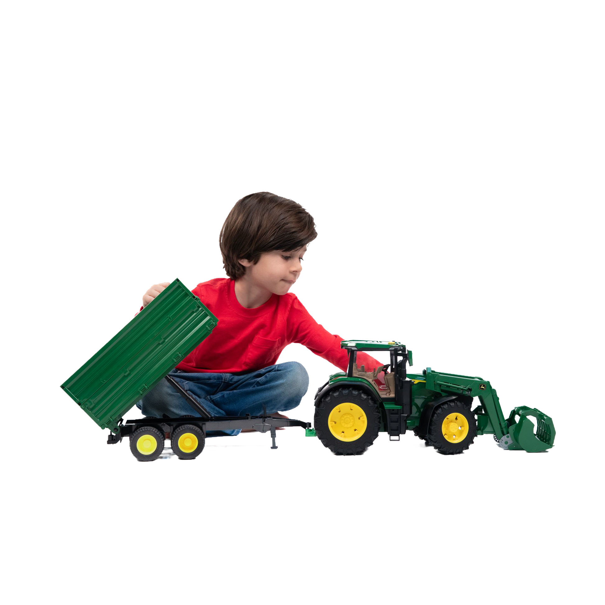 Child in red shirt playing with green tractor and tipping trailer from Vehicles & Remote Controlled Toys collection
