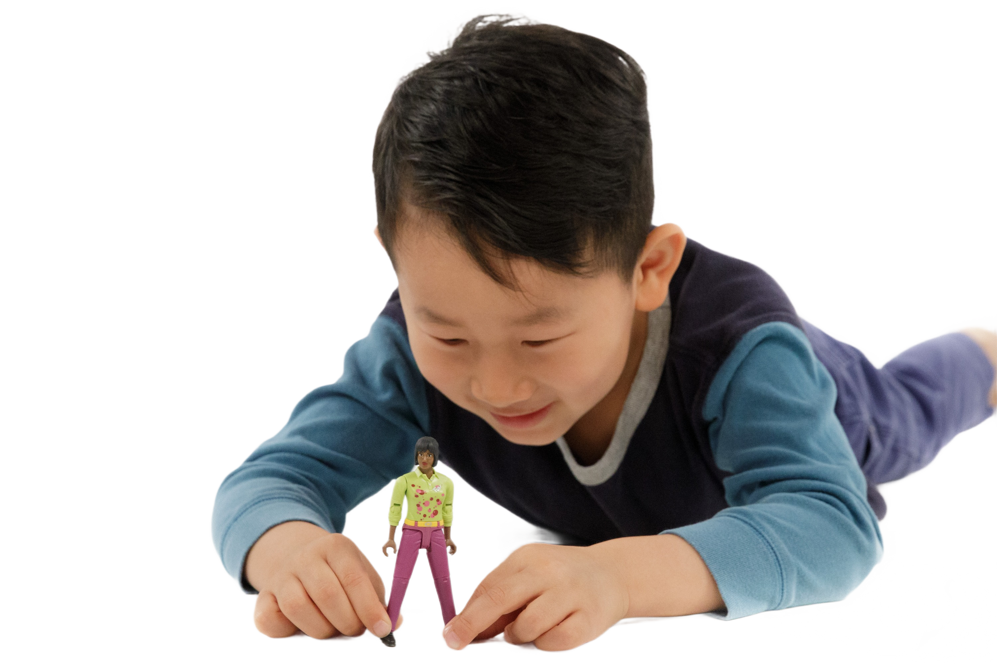 Child in blue and navy shirt playing with a medium skin tone toy woman figure wearing pink pants and a yellow top