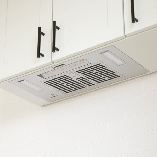 Under-cabinet stainless steel insert ventilation system with control panel in Bosch range hoods and Kitchen & Kitchenware collections