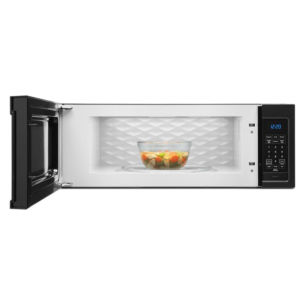 Over the range microwave with open door showing clear bowl of cooked vegetables inside in kitchen appliance setting