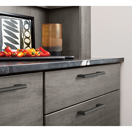 Matte black cabinet pull with 3-3/4 inch center spacing installed on gray kitchen drawers for home improvement projects
