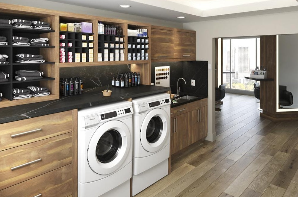White front-load washer and dryer set in wood cabinetry with black countertop in modern laundry room from Dryers collection