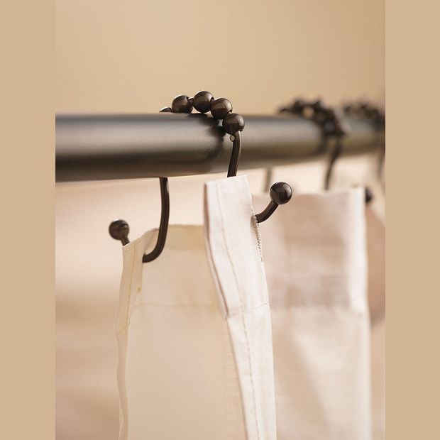 Old World Bronze shower curtain hooks with decorative beaded design hanging on dark metal rod for home improvement
