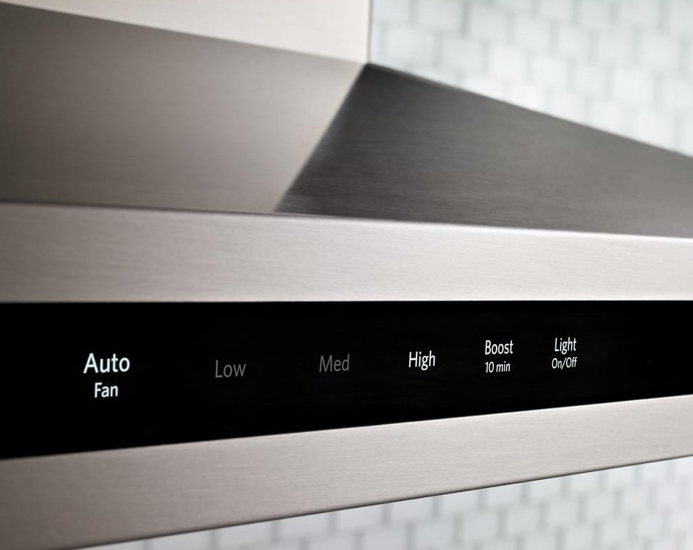 Close-up of brushed stainless steel control panel on island-mount canopy hood with illuminated speed and light settings, featured in Island Range Hoods and Kitchen & Kitchenware collections.