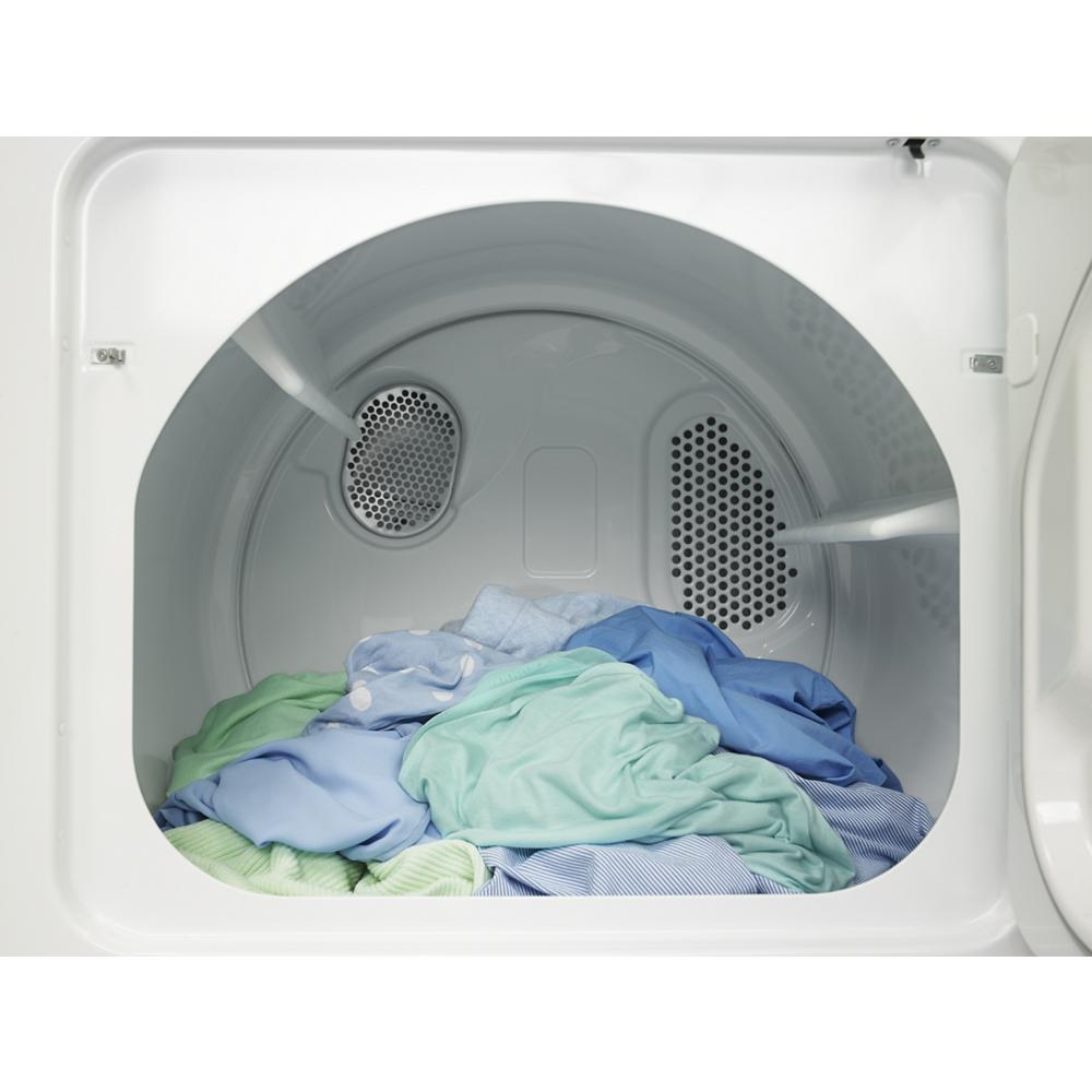 Interior view of a white top load electric dryer drum with mixed laundry inside from dryer appliances collection