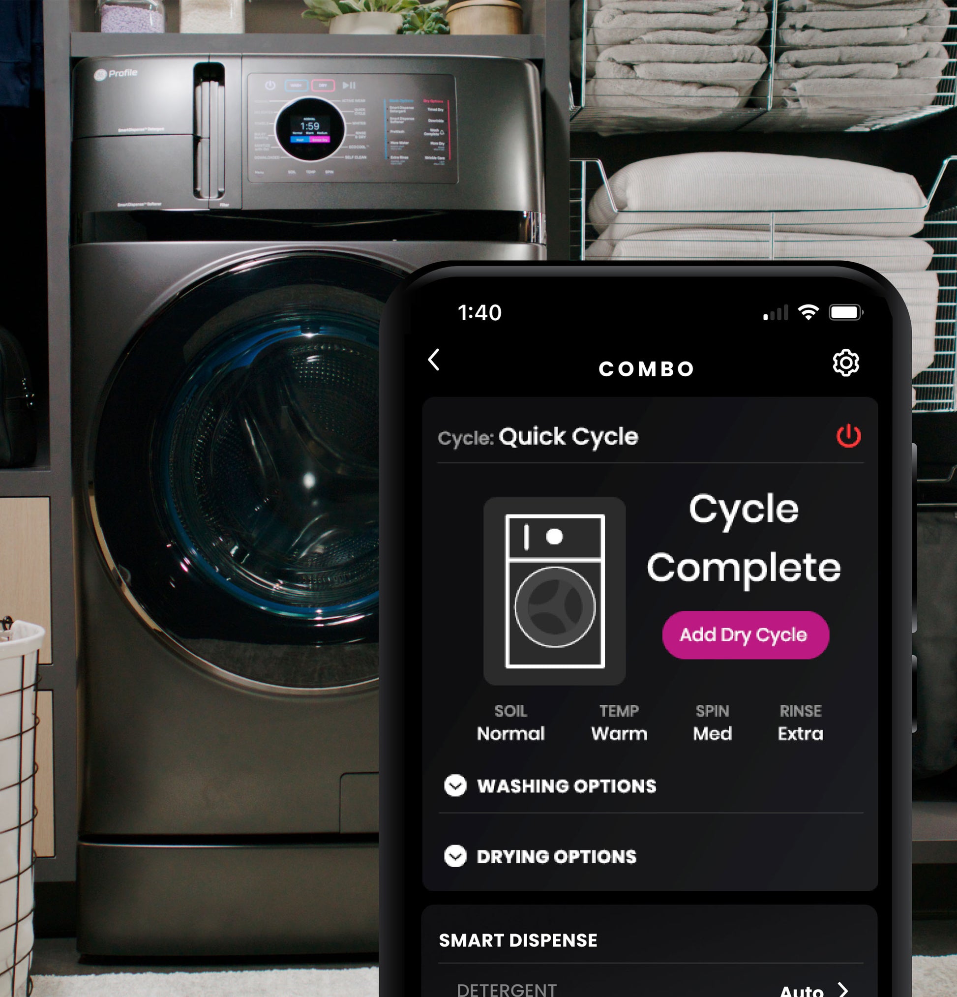 Dark gray washer/dryer combo in laundry room with smartphone app showing completed quick wash cycle and drying options