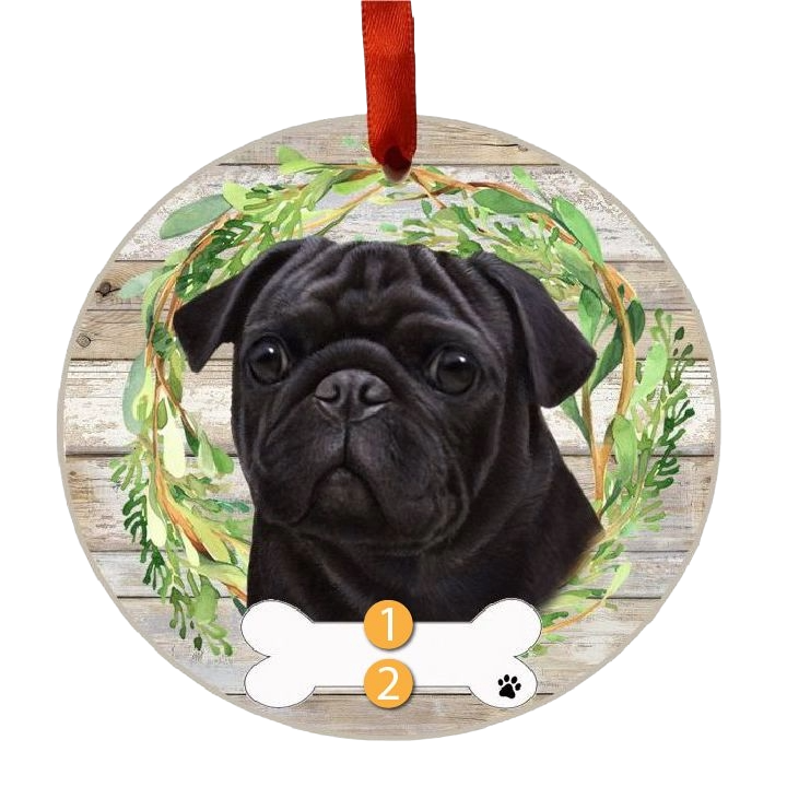 Round wooden Christmas ornament featuring a black pug face with greenery wreath and red hanging ribbon