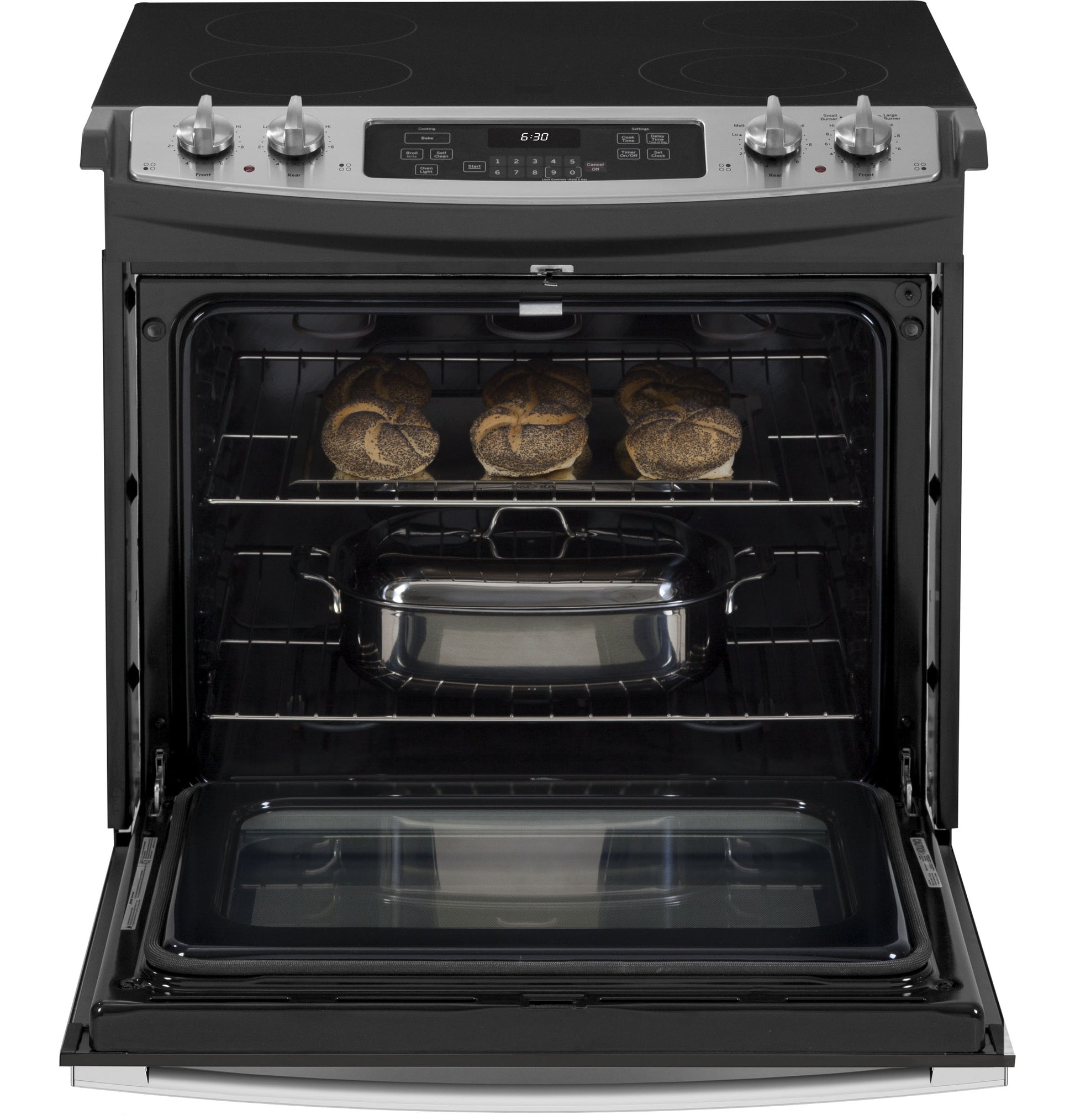 Open drop-in electric range with black glass cooktop, stainless steel control panel, and food baking inside oven door open