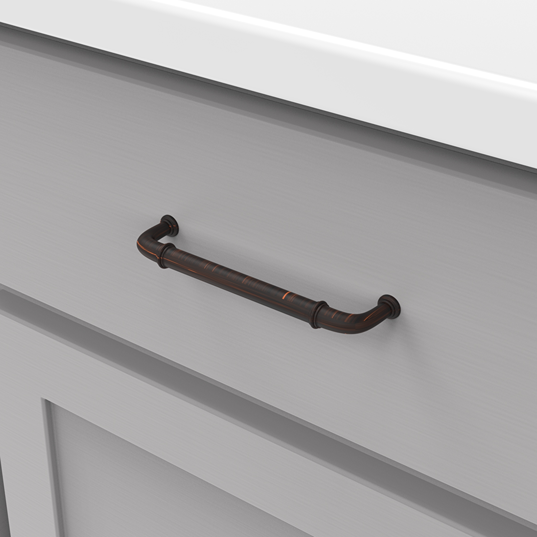 Vintage bronze cottage-style cabinet pull on light gray drawer, suitable for hardware and furniture accessories under $50