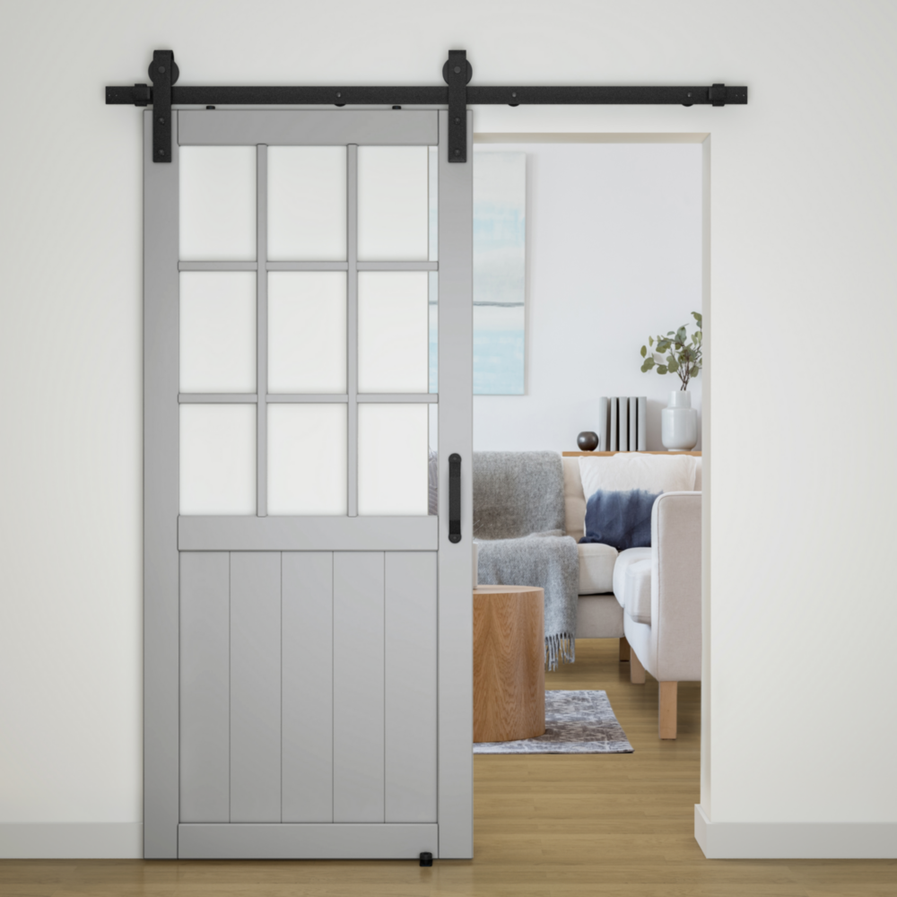 Matte black hardware kit with two-piece track installed on gray interior barn door for home improvement projects