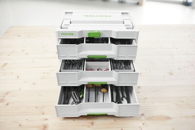 White and green Festool tool organizer with multiple drawers for woodworking tools and workshop storage accessories