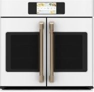 White built-in double-door wall oven with stainless steel handles and digital touchscreen control in modern kitchen setting