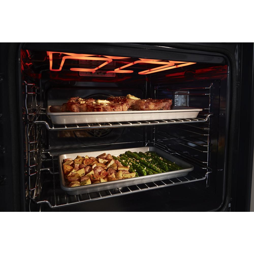 Inside view of double wall oven baking meat, potatoes, and asparagus in Kitchen & Kitchenware appliances collection