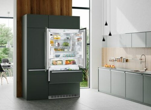 Built-in dark green French door refrigerator with open doors showing organized shelves in modern kitchen appliances collection