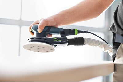 Handheld Festool random orbit sander with dust extraction used for smooth finishing in power tools and home improvement