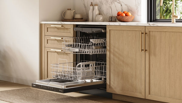 Open black 24-inch dishwasher integrated into modern wood cabinetry with marble countertop in kitchen setting