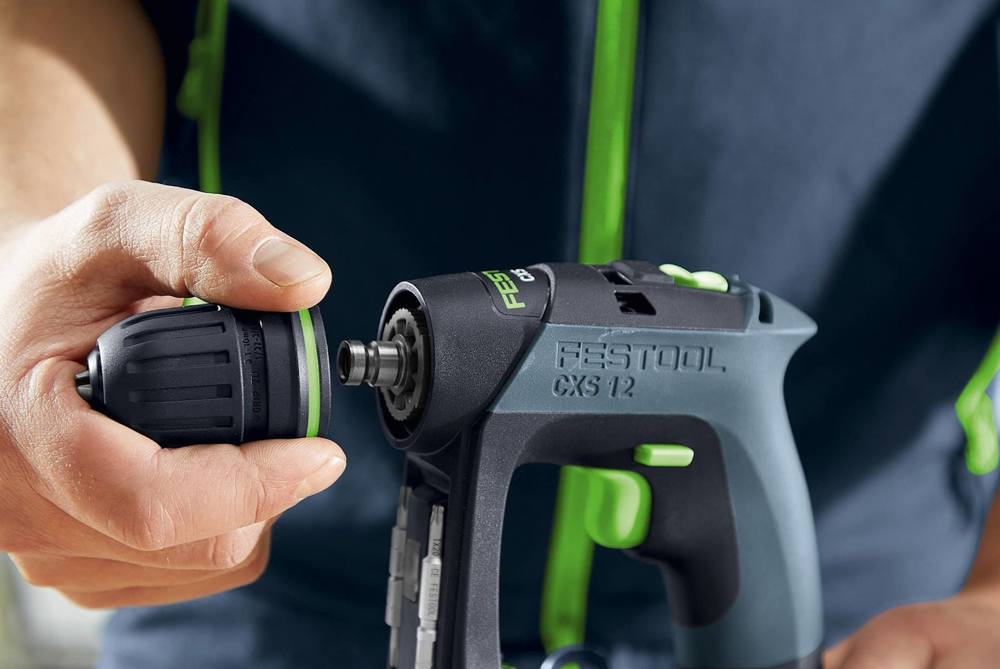 Close-up of person attaching drill bit to compact cordless drill from Festool woodworking power tools collection