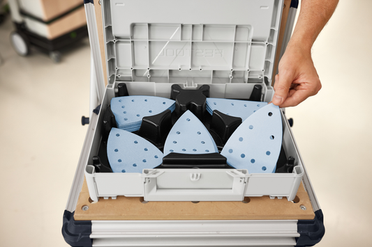 Hand removing blue delta-shaped sanding abrasives from organized Festool Granat Abrasives Systainer in tool accessories collection