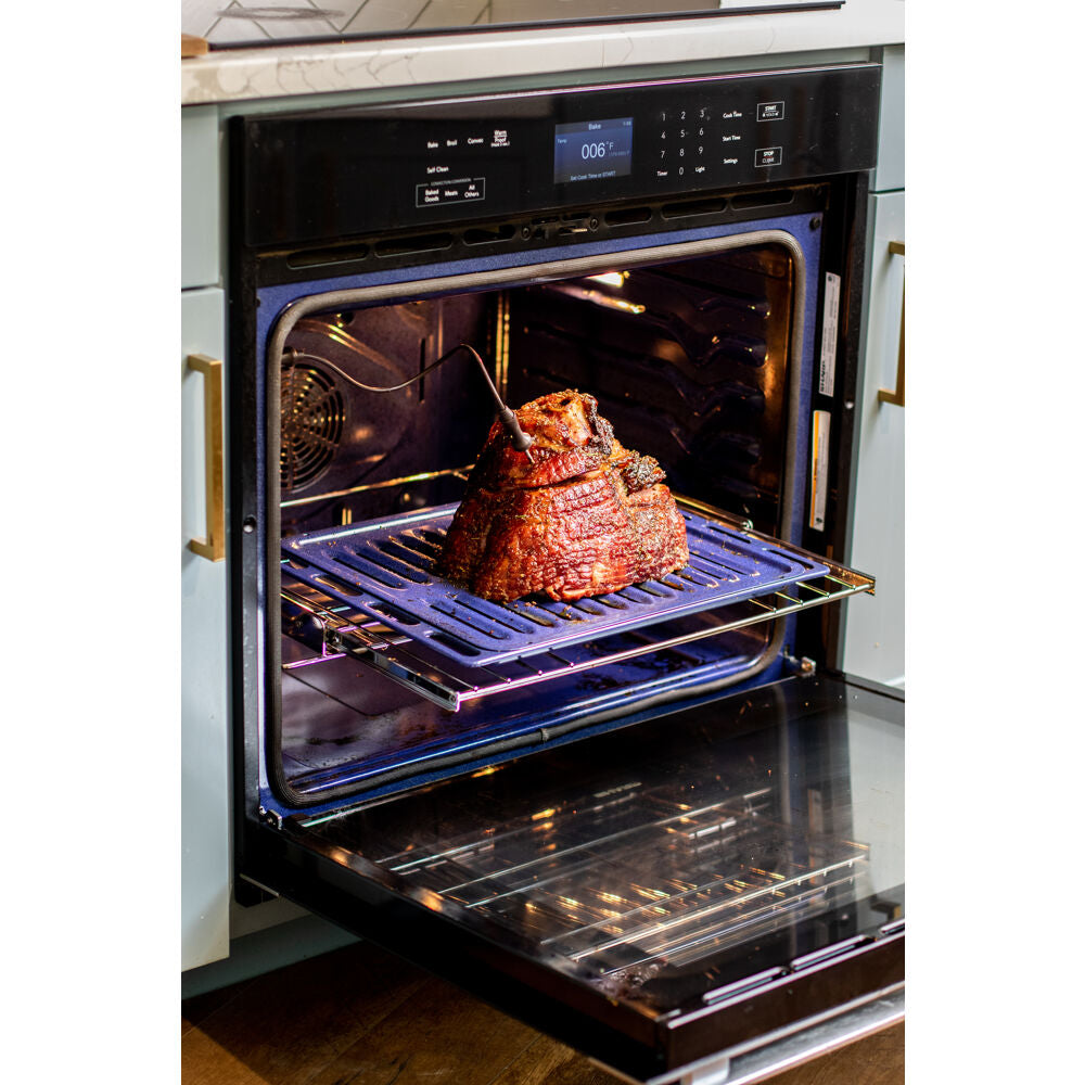 Open built-in electric wall oven with black glass front and stainless steel accents cooking roast from Kitchen & Kitchenware collection