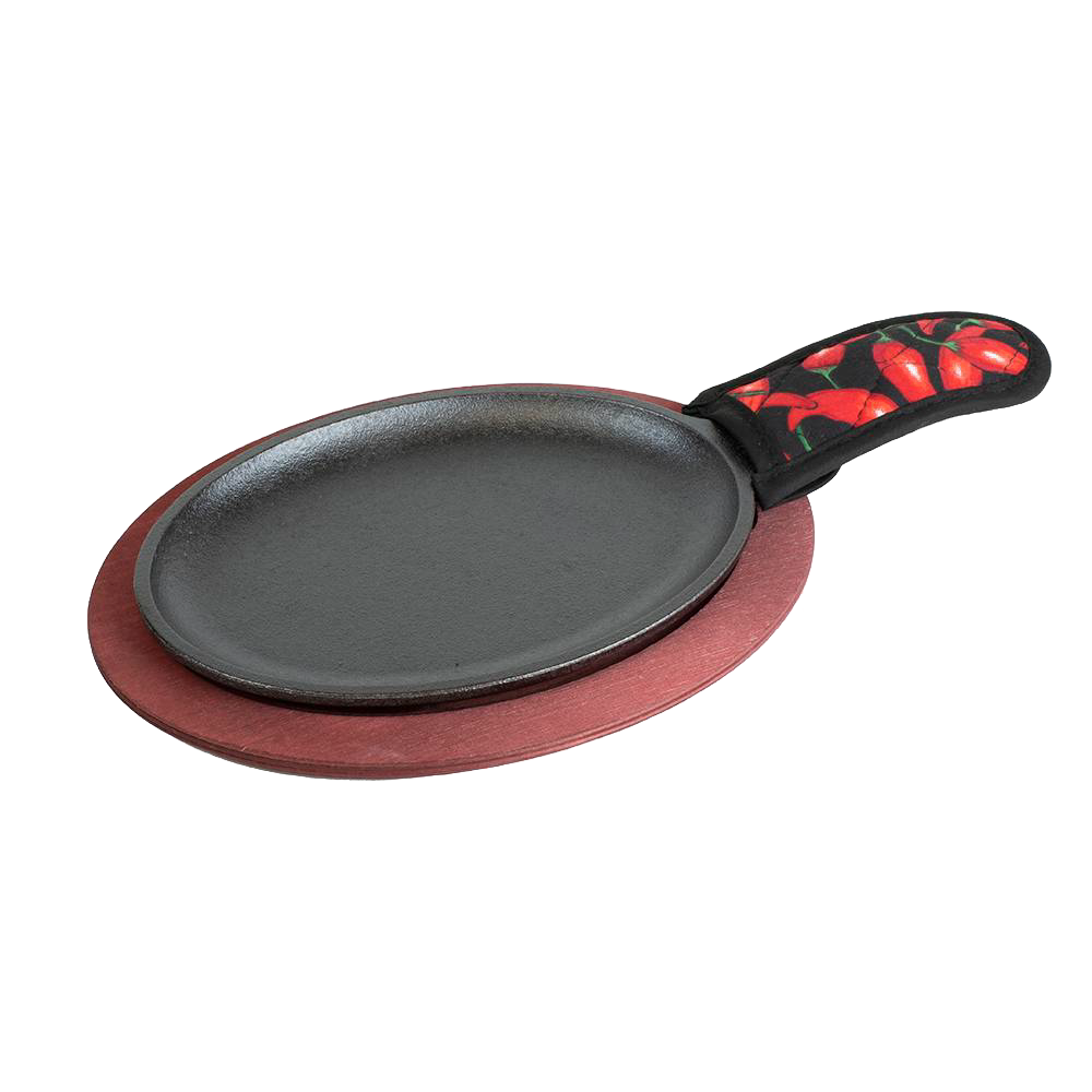 Cast iron fajita skillet with chili pepper-patterned handle resting on a wooden serving platter in kitchenware collection