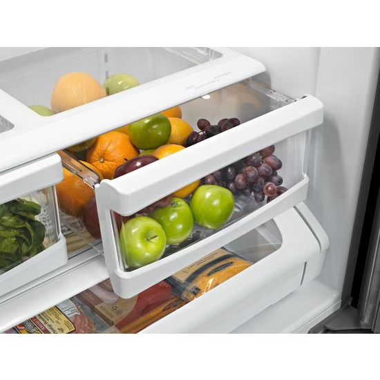 Crisp white refrigerator door bin filled with fresh green apples and red grapes in kitchen appliances collection