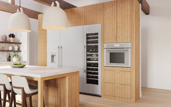Modern kitchen with built-in stainless steel wall oven and wine cooler integrated into wood cabinetry from Thermador collection