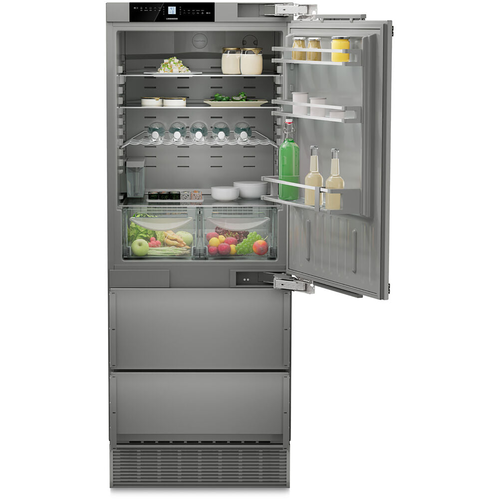 Built-in stainless steel refrigerator with open door showing organized interior and vegetable drawers in Appliances collection