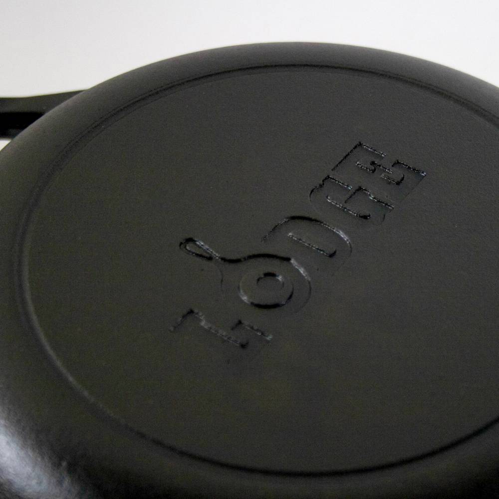 Black cast iron cookware with embossed Lodge logo for durable use in kitchenware and cooking collections