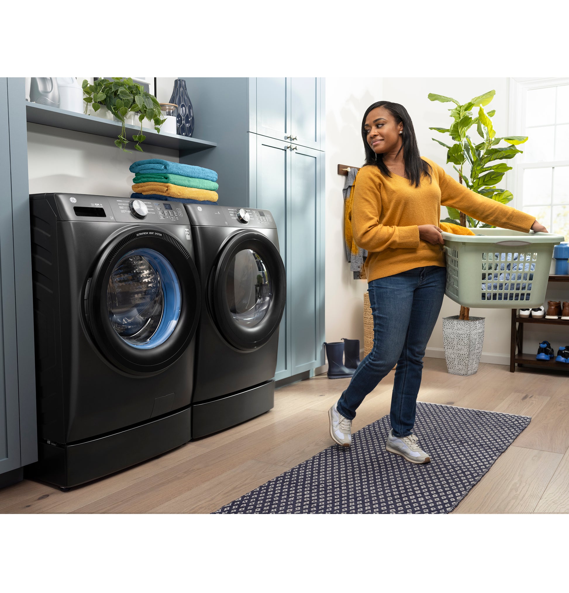 Modern laundry room with black front load washer and matching dryer in bright space from Washers & Dryers collection