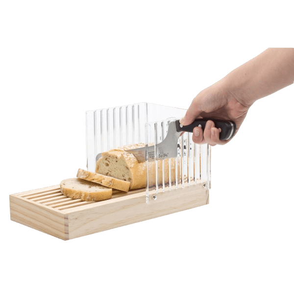 Hand using knife to cut bread with wooden base and clear acrylic adjustable slicing guide in kitchenware tools collection