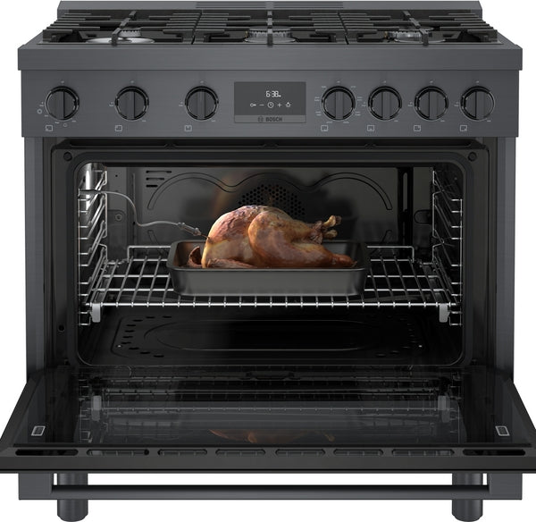 Open black stainless steel dual fuel range oven with roasted whole chicken on wire rack in kitchen appliance collection