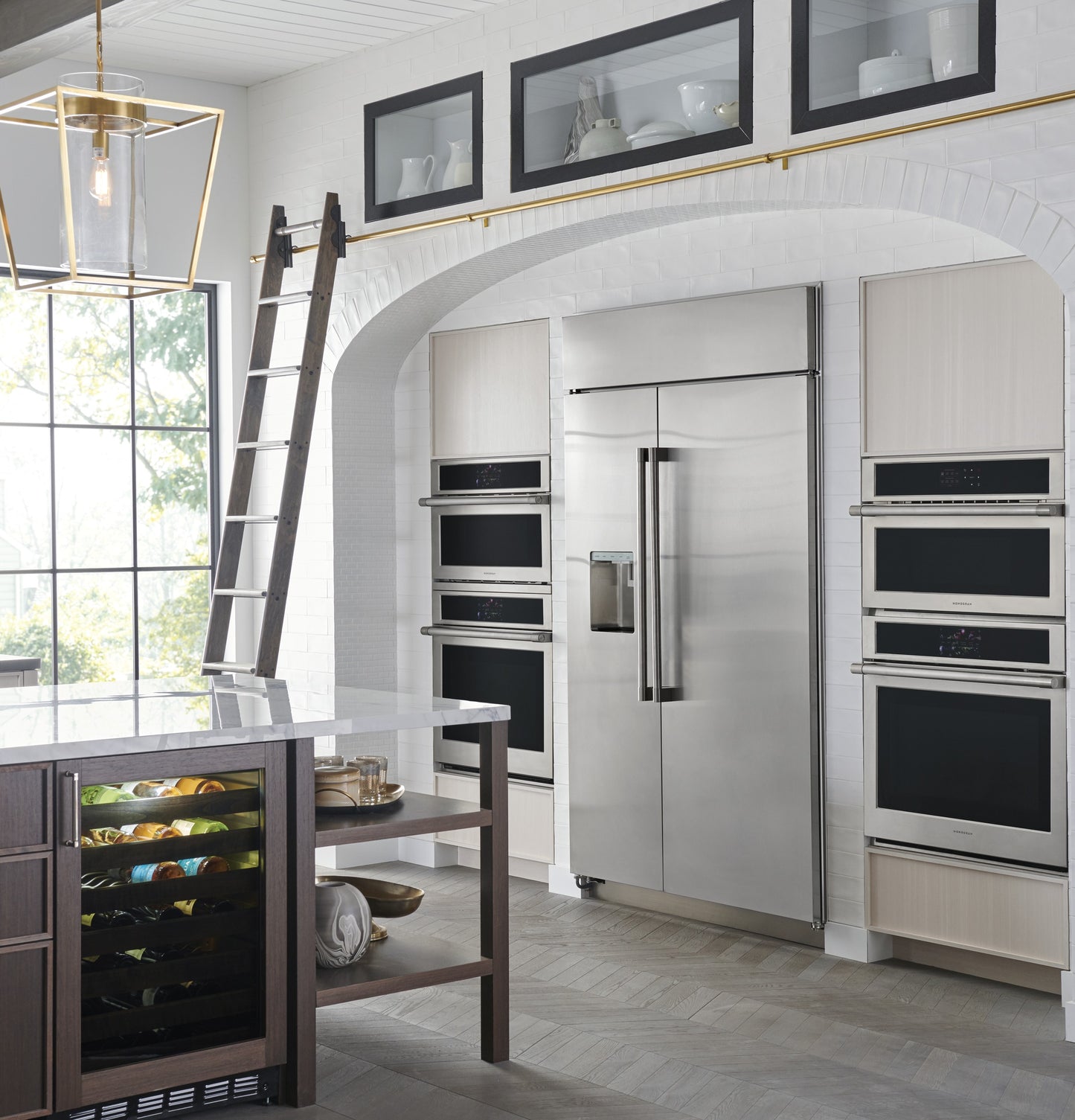 Modern kitchen featuring built-in stainless steel wall ovens, large refrigerator, and wine cooler in home appliances collection