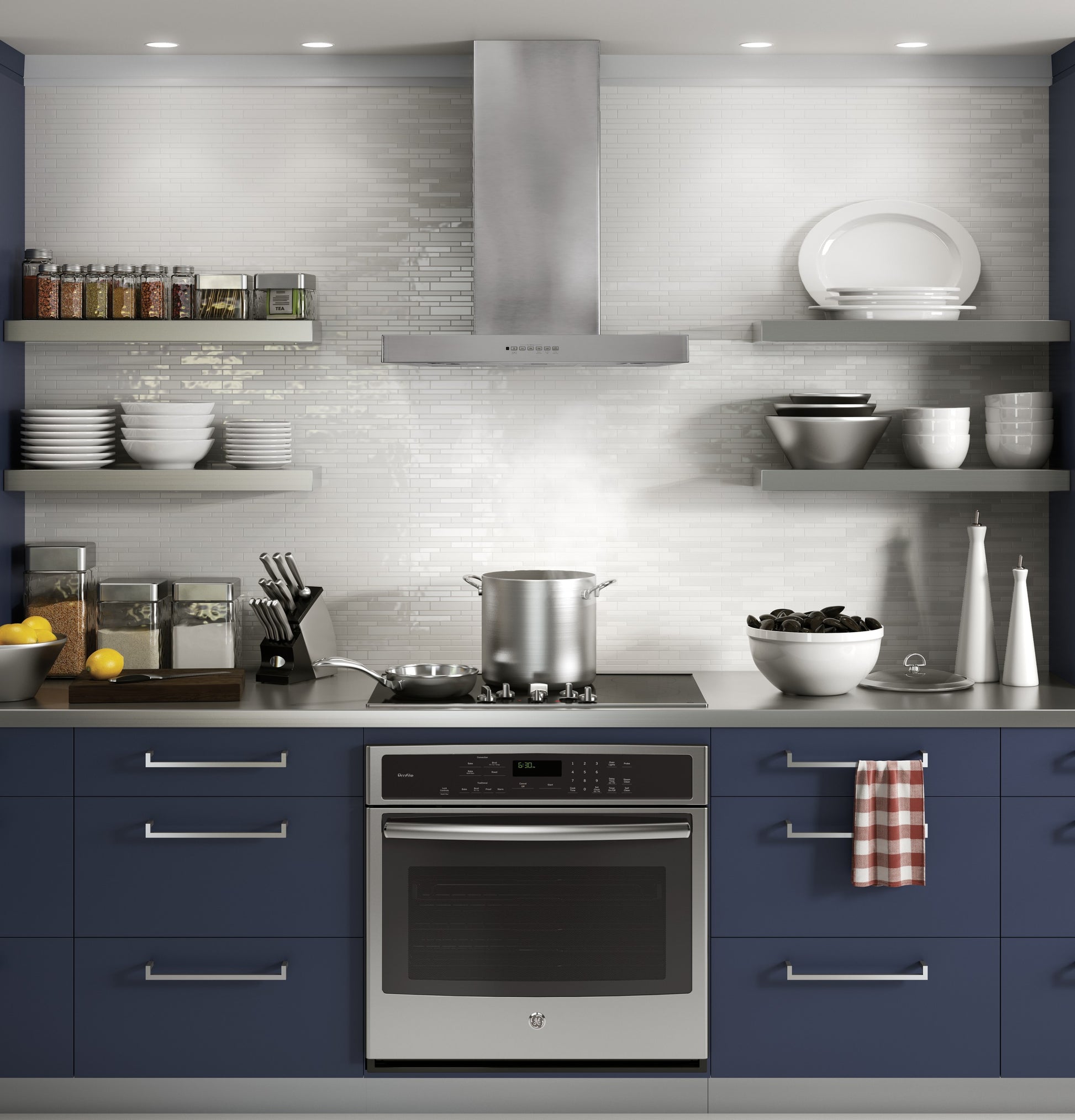 Contemporary kitchen with stainless steel wall mount hood, blue cabinets, gas cooktop, and open shelving with dishware
