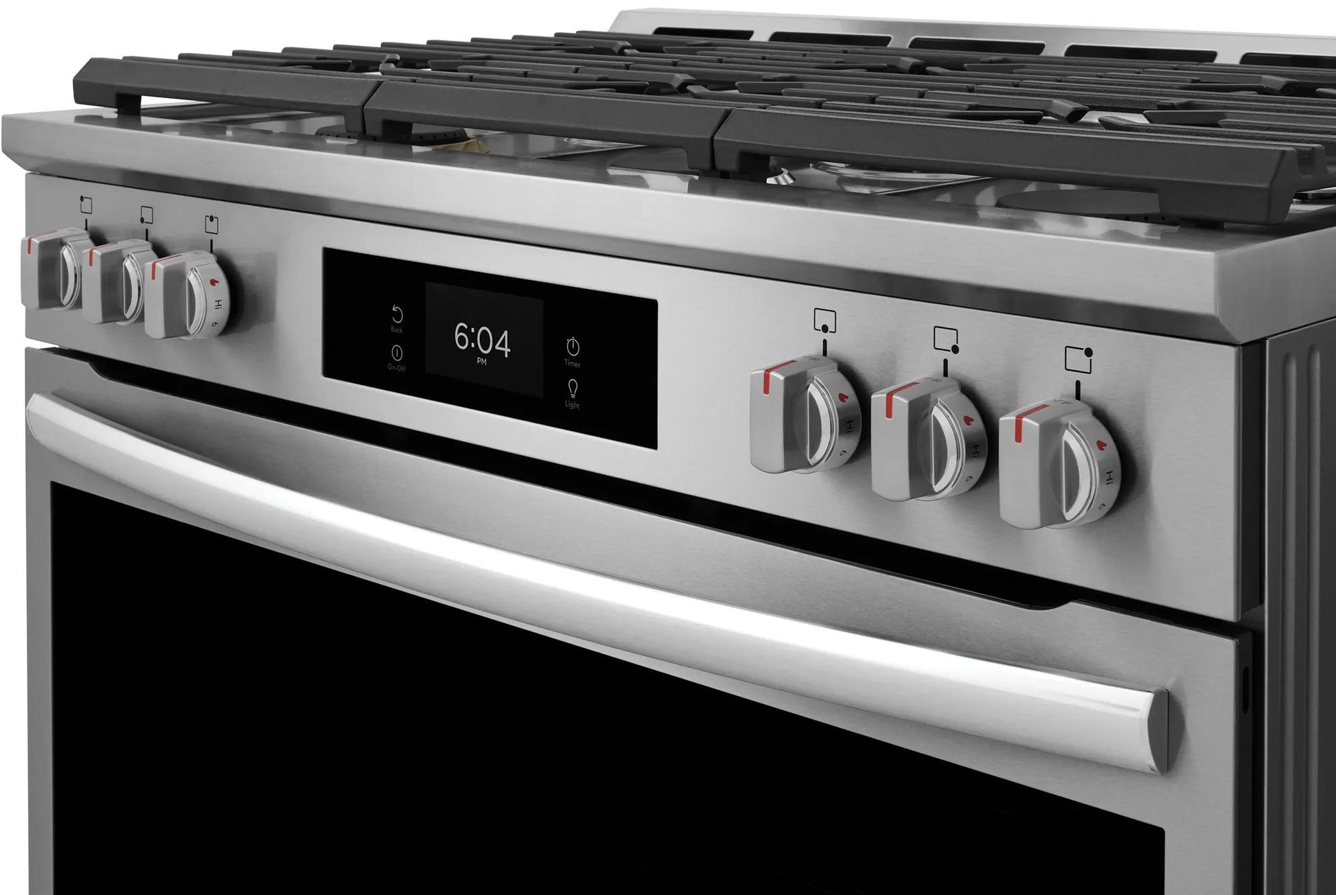 Close-up of stainless steel dual-fuel range control panel with digital display and six burner cooktop knobs