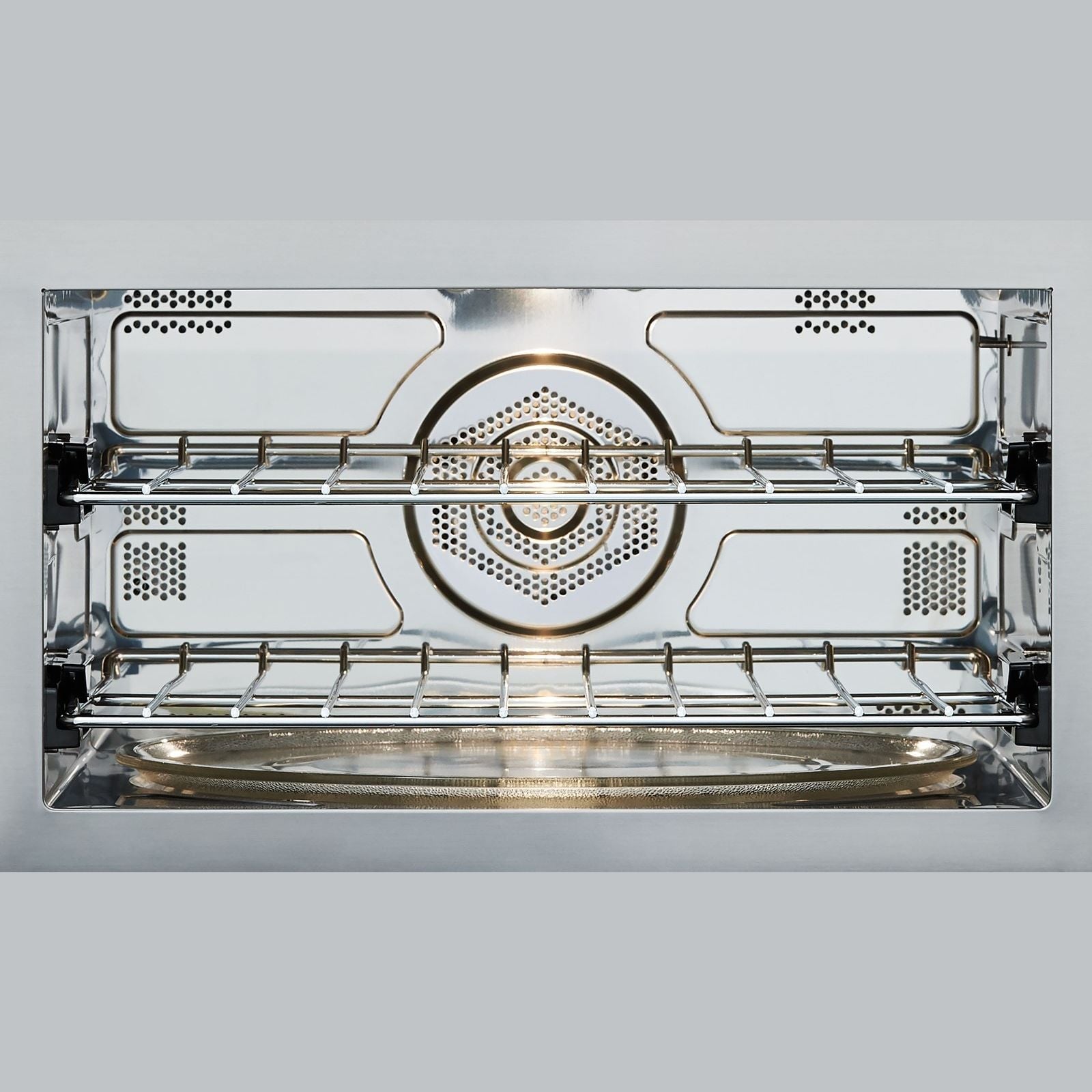 Interior view of stainless steel multifunctional oven with wire racks for kitchen and appliances collections