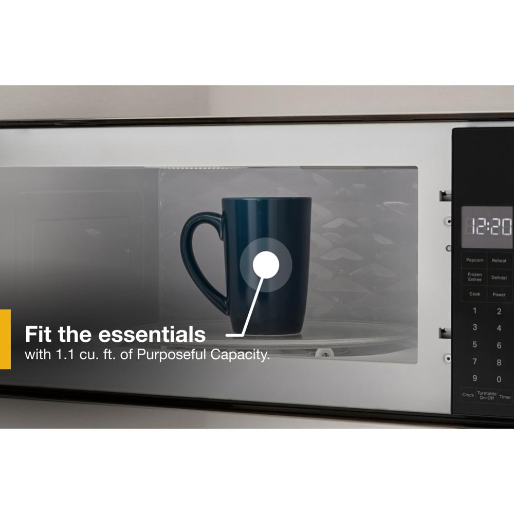 Built-in microwave with stainless steel trim showing blue mug inside in modern Kitchen & Kitchenware setting