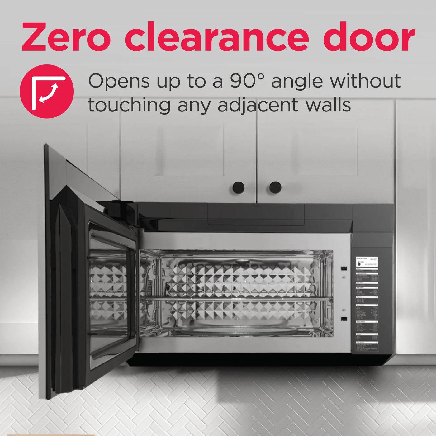 Open over-the-range microwave door at 90-degree angle with stainless steel interior in modern kitchen setting