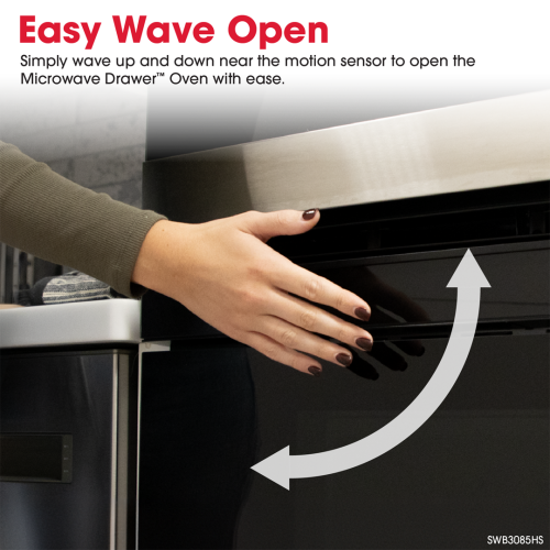 Hand activating motion sensor to open the black and stainless steel microwave drawer in kitchen appliances setting
