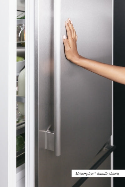 Hand reaching to open stainless steel built-in refrigerator column with sleek vertical handle from Thermador Appliances collection