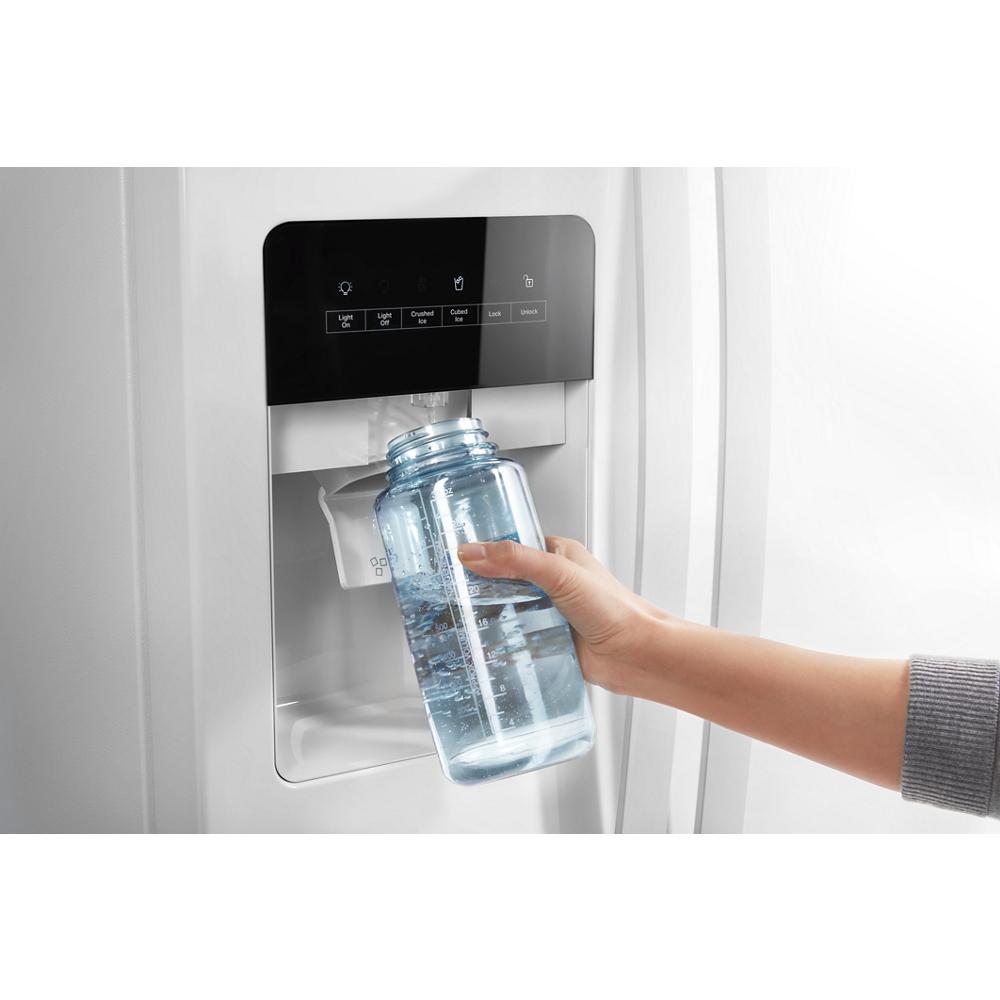 Hand filling reusable water bottle from built-in dispenser on white 36-inch side-by-side refrigerator in kitchen appliance collections