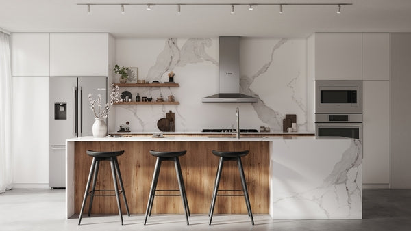 Modern kitchen with built-in stainless steel microwave, marble countertops, wooden island, and black bar stools in appliances collection