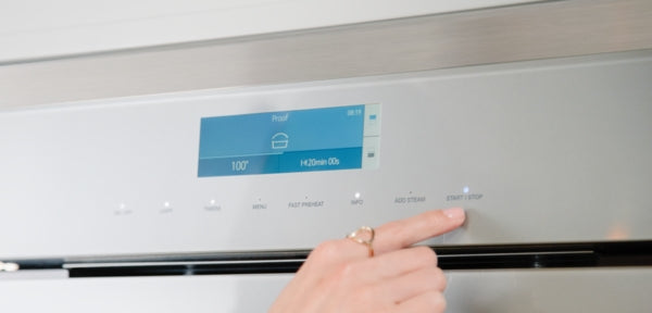 Close-up of digital display and control panel with timer and cooking mode on stainless steel wall oven in Kitchen & Kitchenware collection