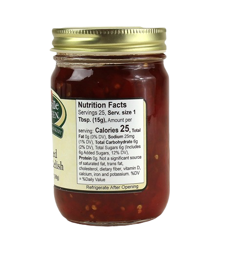 Glass jar filled with spicy red pepper relish sealed with a gold metal lid for pantry storage use